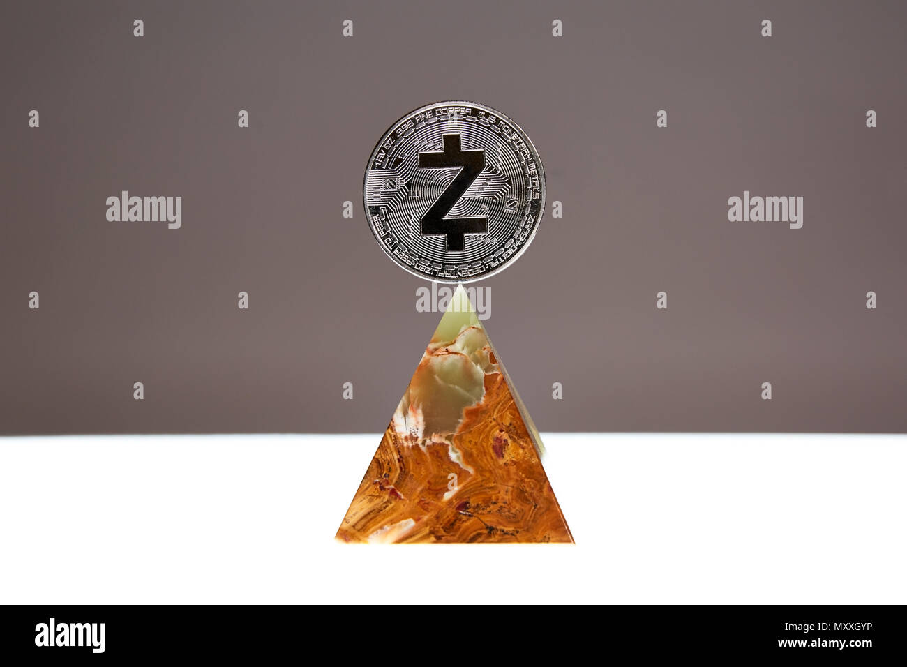 ZCash Coin sitting a top a translucent Onyx Stone. Stone symbolizes, personal power, change, facing fears.  All things people who trade crypro face Stock Photo
