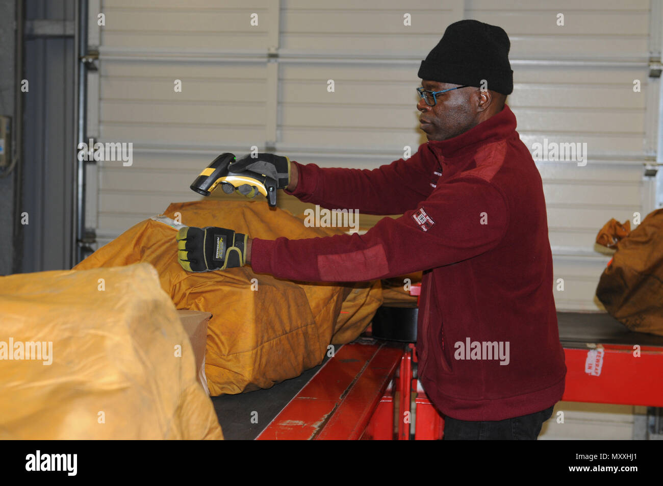 Parcels are scanned into the Automated Military Postal System by Ray