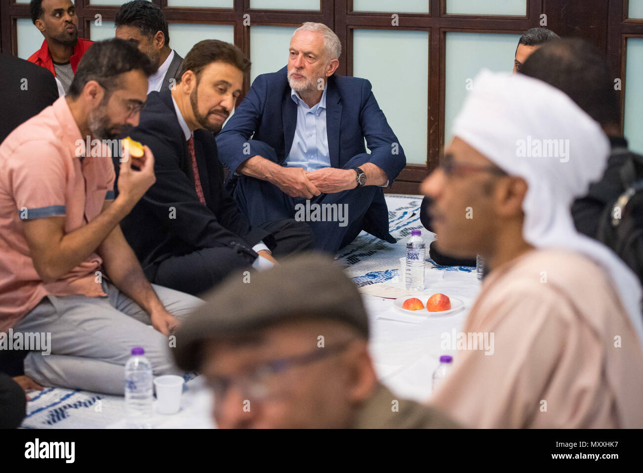 Labour leader Jeremy Corbyn (centre) joins worshippers for iftar during a visit to the Al-Manaar Muslim Cultural Heritage Centre, in Westbourne Park, London. Stock Photo