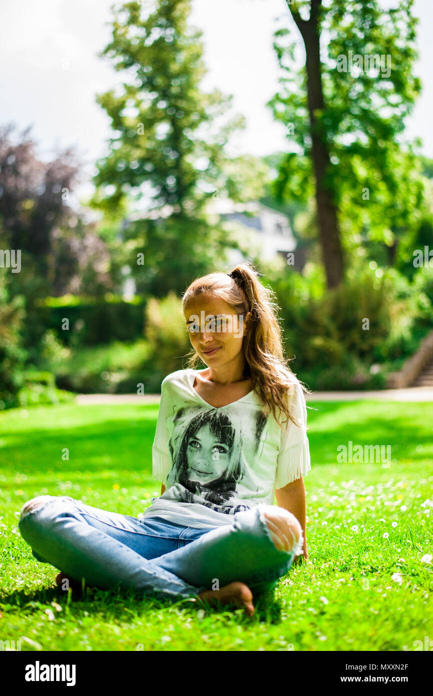 Portrait of a smiling woman in a public park, Luxembourg Stock Photo