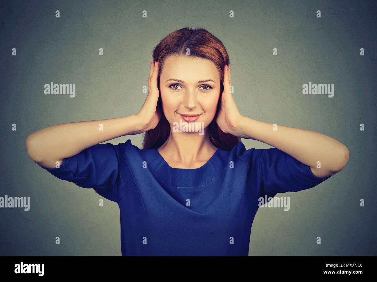 Smart young woman covering ears unwilling to hear rumors and stupid things Stock Photo