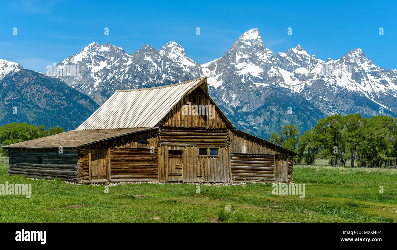 Moulton Barn - A spring morning view of Moulton Barn and Teton Range in Mormon Row historic district of Grand Teton National Park, Wyoming, USA. Stock Photo