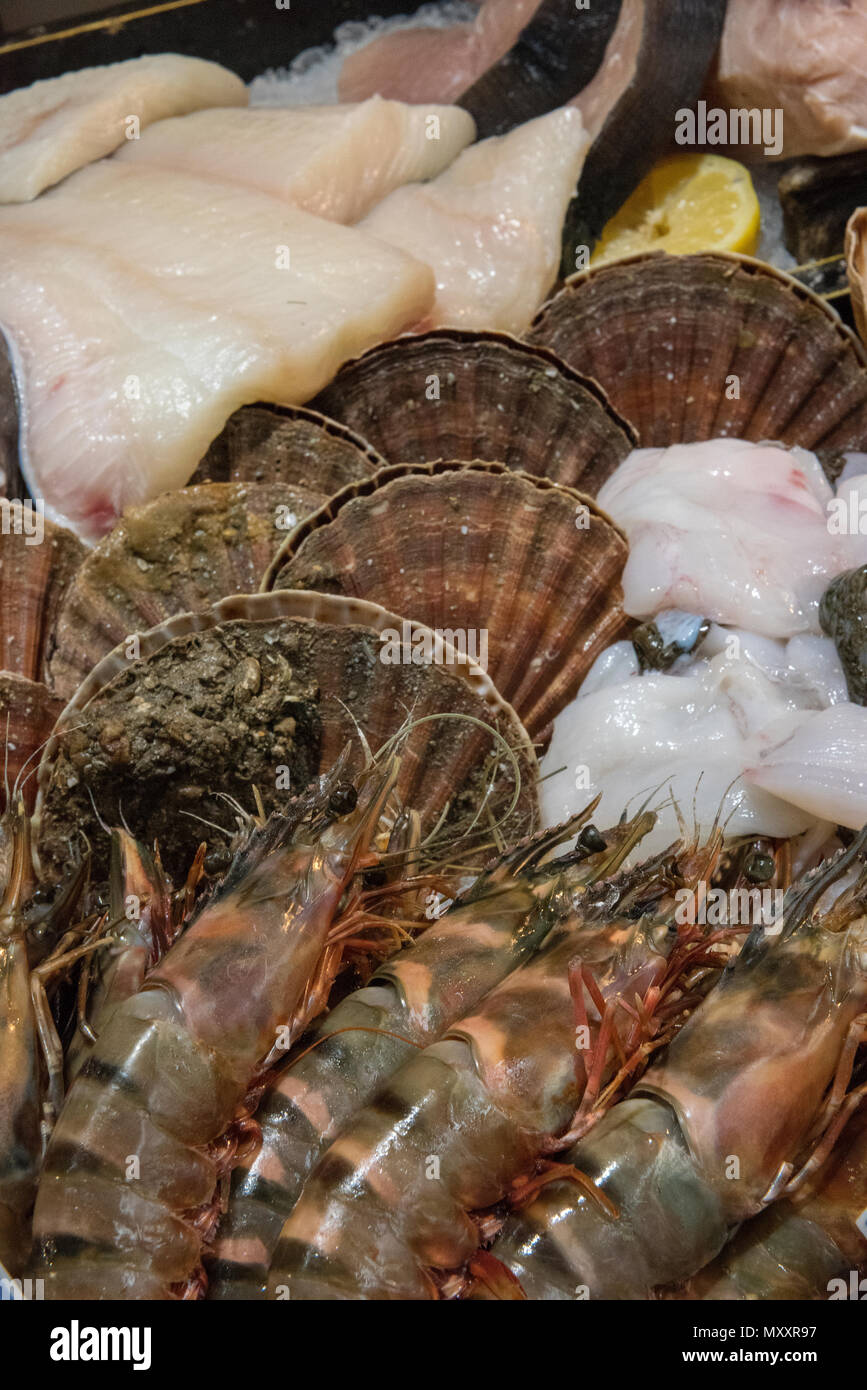 A variety or selection of fresh shellfish and seafood on sale at a fishmongers stall on borough market in central London. Fresh fish catch of the day. Stock Photo