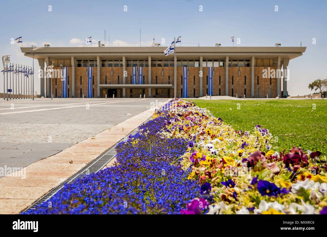 JERUSALEM, ISRAEL. June 10, 2014. A beautiful stock image of the Knesset, Israeli parliament building facade, Knesset exterior with colorful flowers. Stock Photo