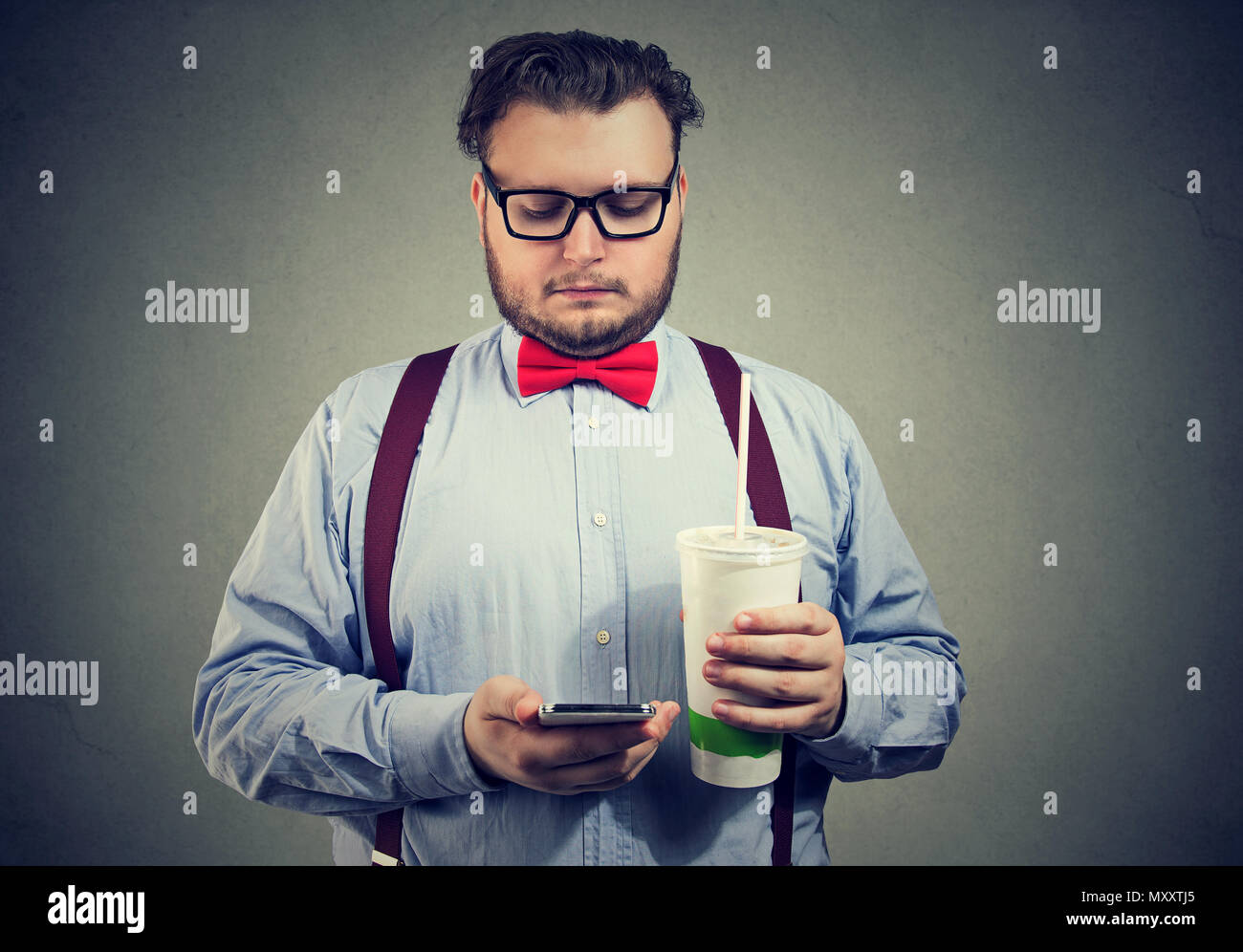 Formal Overweight Man Holding Cup Of Sugar Soda And Using Smartphone For Calories Tracking On Gray Background Stock Photo Alamy Formal Overweight Man Holding Cup Of Sugar Soda And Using Smartphone For Calories Tracking On Gray Background Stock Photo Alamy