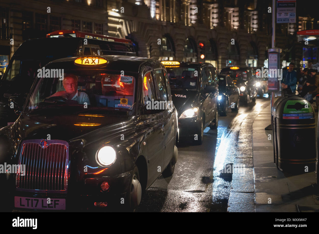London, UK - October 2017. A row of the iconic black cabs on Regent Street at night. Landscape format. Stock Photo