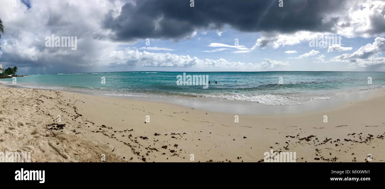 Panorama of a beautiful day at Bayshore / Pebbles Beach (Carlisle Bay) near Bridgetown Barbados (Caribbean Island) - white sand, waves and blue sky Stock Photo