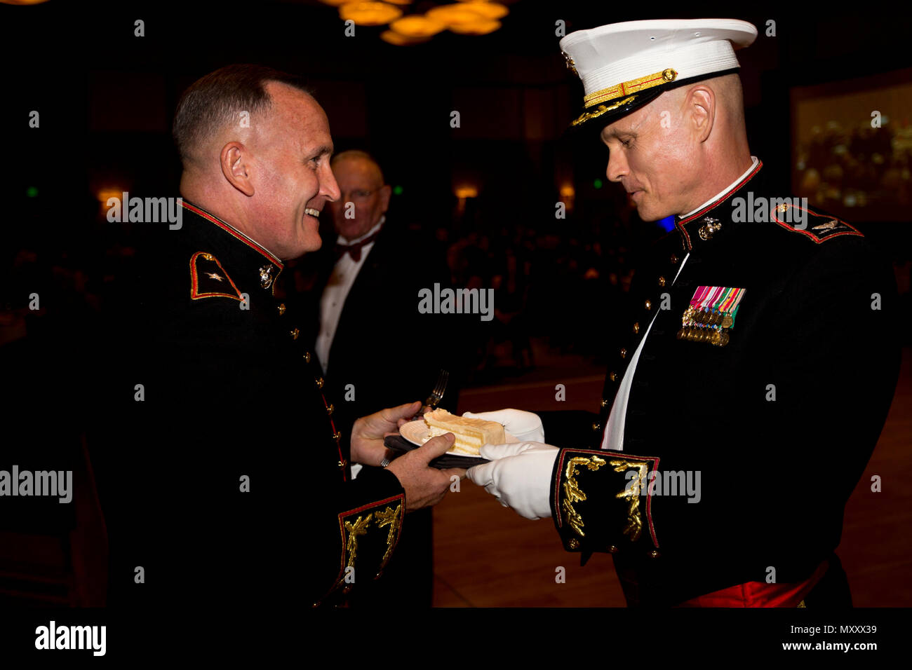 U.S. Marine Corps Brig. Gen. William M. Jurney, left, commanding general of Marine Corps Recruit Depot (MCRD) San Diego and  the Western Recruiting Region (WRR), passes a piece of cake to Col. Mark M. Tull, chief of staff of MCRD San Diego and the WRR, at the Hilton San Diego Bayfront hotel, San Diego, Calif., Nov. 12, 2016. Tull was given a piece of cake as the oldest active duty Marine during the 241st Marine Corps birthday celebration. (U.S. Marine Corps photo by Lance Cpl. Robert G. Gavaldon) Stock Photo