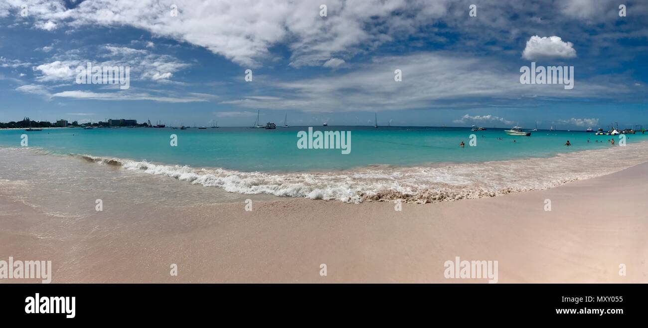 Panorama of a beautiful day at Bayshore / Pebbles Beach (Carlisle Bay) near Bridgetown Barbados (Caribbean Island) - white sand, waves and blue sky Stock Photo