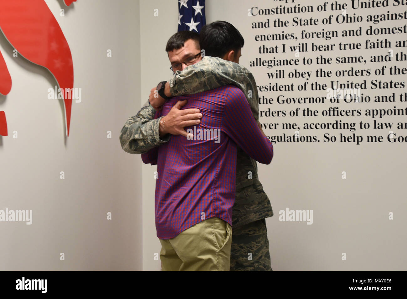 Senior Master Sgt. Roger Burton, the fire chief at the 179th AW, embraces  his son Cooper Burton on Dec. 2, 2016, at the 179th Airlift Wing,  Mansfield, Ohio. They both recited the