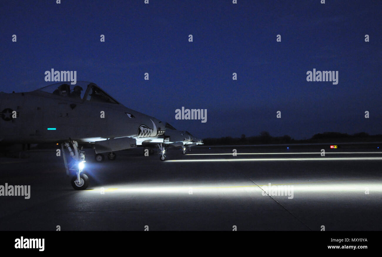 Four A-10 Thunderbolt IIs prepare to take-off from Whiteman Air Force Base, Missouri, Dec. 6, 2016. Four 303rd Fighter Squadron pilots conducted night close-air-support training with 14th Air Support Operations Squadron joint terminal attack controllers from Pope Army Airfield, N.C. (U.S. Air Force photo/Senior Airman Missy Sterling) Stock Photo