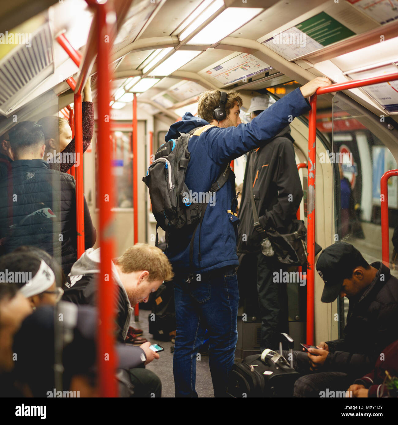 London, UK - October 2017. People commuting on an underground train in London. The Tube handles up to 5 Million passenger per day. Square format. Stock Photo
