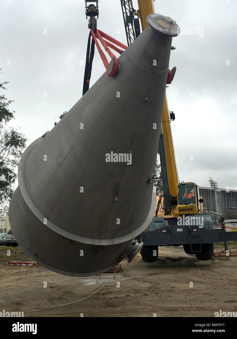 Workers unload four Speece cones delivered Dec. 14, 2016, to an Army Corps of Engineers site along the Savannah River.  The Speece cones, each about 22 feet tall when installed, will dissolve pure oxygen into water extracted from the river, then push the water back into the river. The process will replace dissolved oxygen in the river lost as the Corps of Engineers deepens the harbor from its current 42-foot authorized depth to 47 feet.    The replacement of dissolved oxygen lost to the deepening of the Savannah River forms one of the environmental mitigation actions taken by the Corps for the Stock Photo