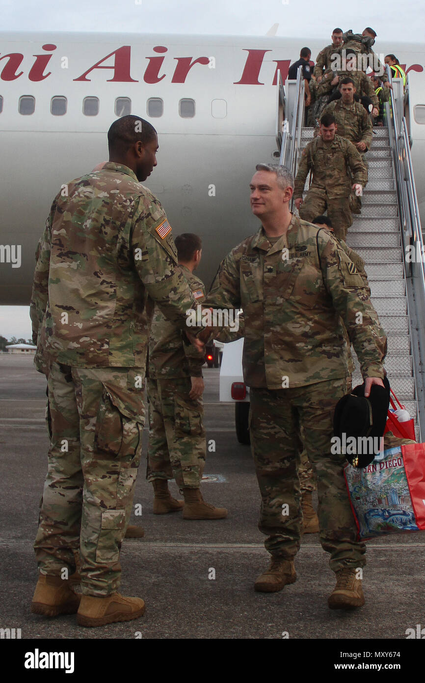 Lt. Col. Jay Wisham (right), commander of 6th Squadron, 8th Cavalry Regiment, 2nd Infantry Brigade Combat Team, 3rd Infantry Division, arrives at Hunter Army Airfield, Georgia, December 13, 2016. Troopers of 6-8 Cav. returned from a five-month rotation supporting Joint Multinational Training Group-¬Ukraine, building sustainable training capacity and capability within Ukrainian land forces. (U.S. Army photo by Sgt. Joshua Laidacker/Released) Stock Photo