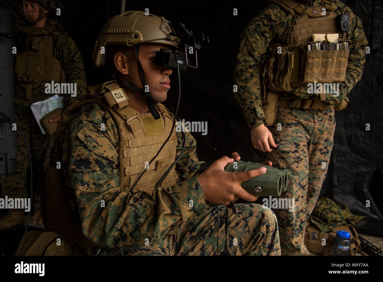 Lance Cpl. Jorge Brito uses the Augmented Immersive Team Trainer to call in mortar fire on virtual targets at Camp Lejeune, N.C., Dec. 13, 2016. Brito is holding a Target Hand-Off System integrated with the AITT to spot out virtual tanks while getting coordinates to call in mortar fire. Brito is a fire support Marine with 2nd Battalion, 10th Marine Regiment, 2nd Marine Division. (U.S Marine Corps photo by Lance Cpl. Juan A. Soto-Delgado) Stock Photo
