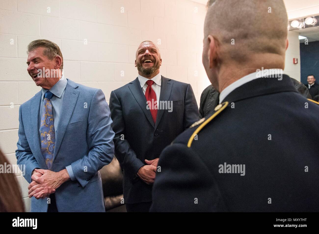 WWE CEO Vince McMahon and Paul 'Triple H' Levesque speak to Army Command Sgt. Maj. John W. Troxell, Senior Enlisted Advisor to the Chairman  of the Joint Chiefs of Staff, before the 14th Annual Tribute to the Troops Event at the Verizon Center in Washington, D.C., Dec. 13, 2016. WWE Tribute to the Troops is an annual event held by WWE and Armed Forces Entertainment in December during the holiday season since 2003, to honor and entertain United States Armed Forces members. WWE performers and employees travel to military camps, bases and hospitals, including the Walter Reed Army Medical Center a Stock Photo