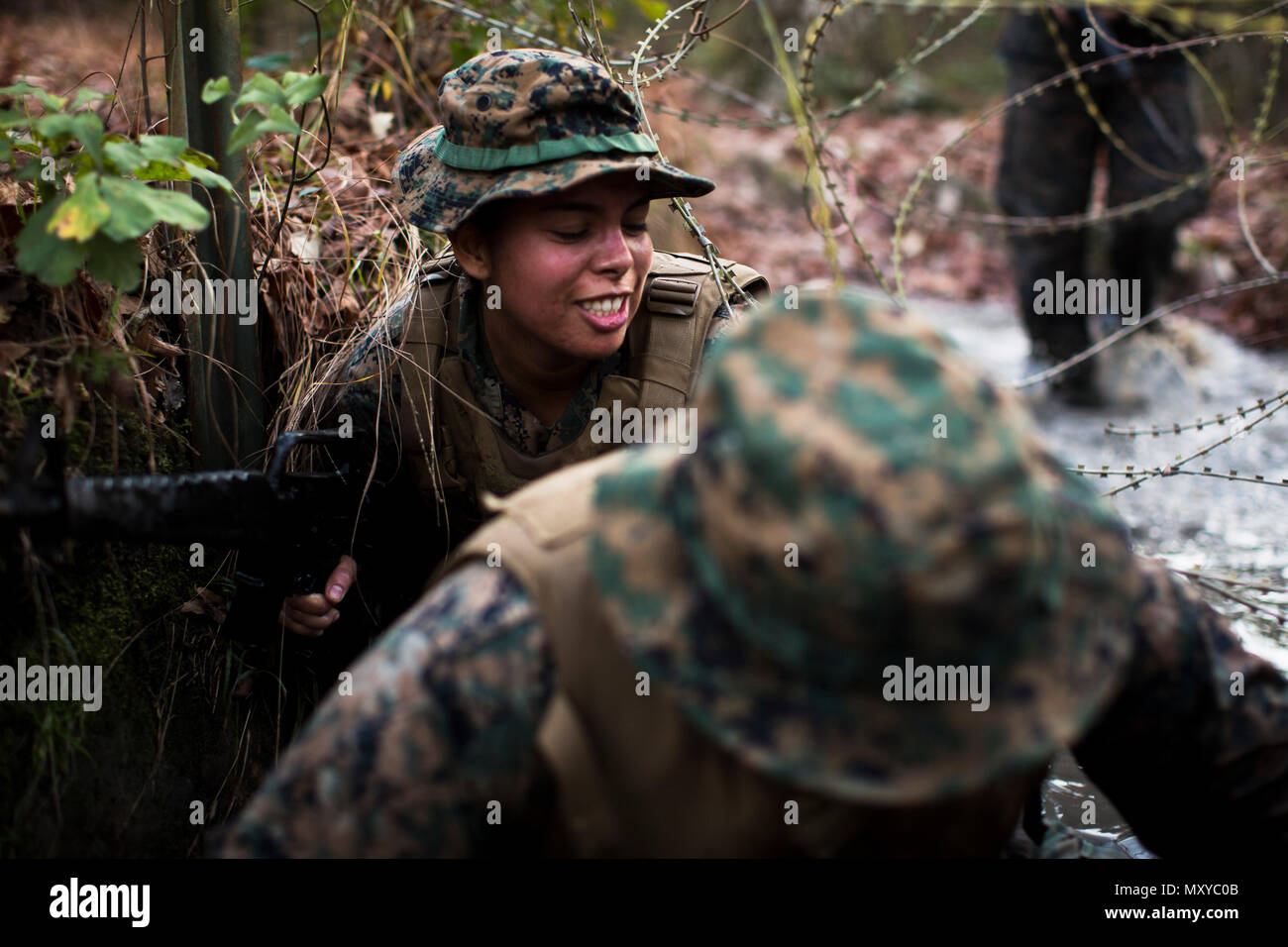 Marine Corps Combat Camera Marines navigate low crawls under barbed ...