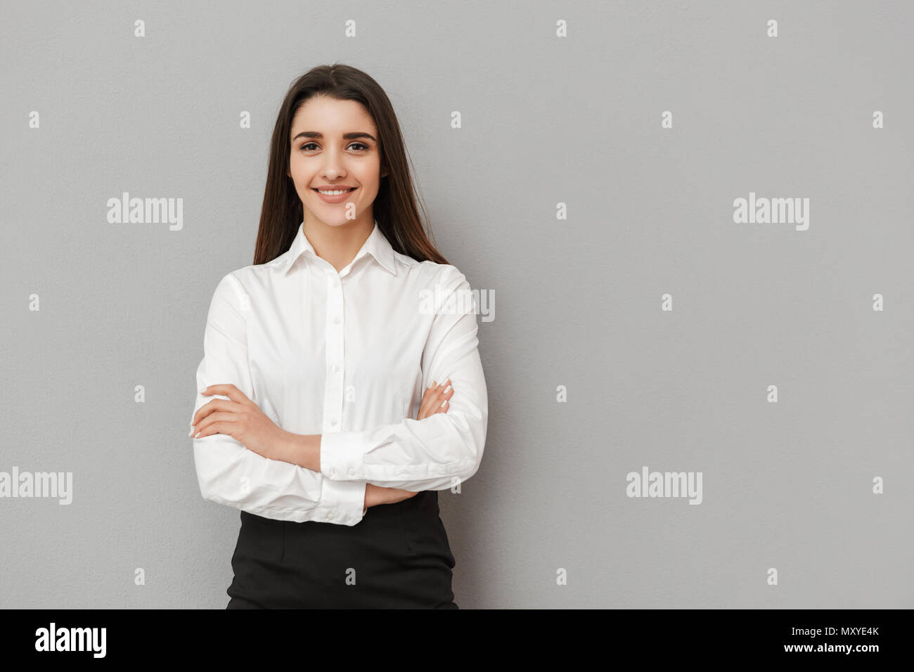 Portrait of caucasian woman with long brown hair in business wear ...