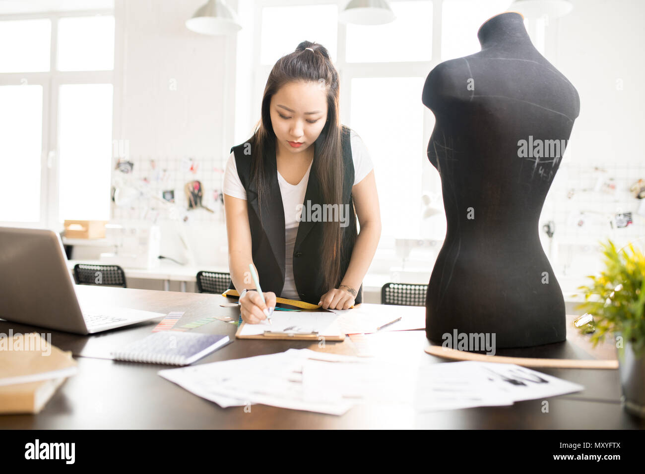 Waist up portrait of focused Asian woman working in fashion design and ...