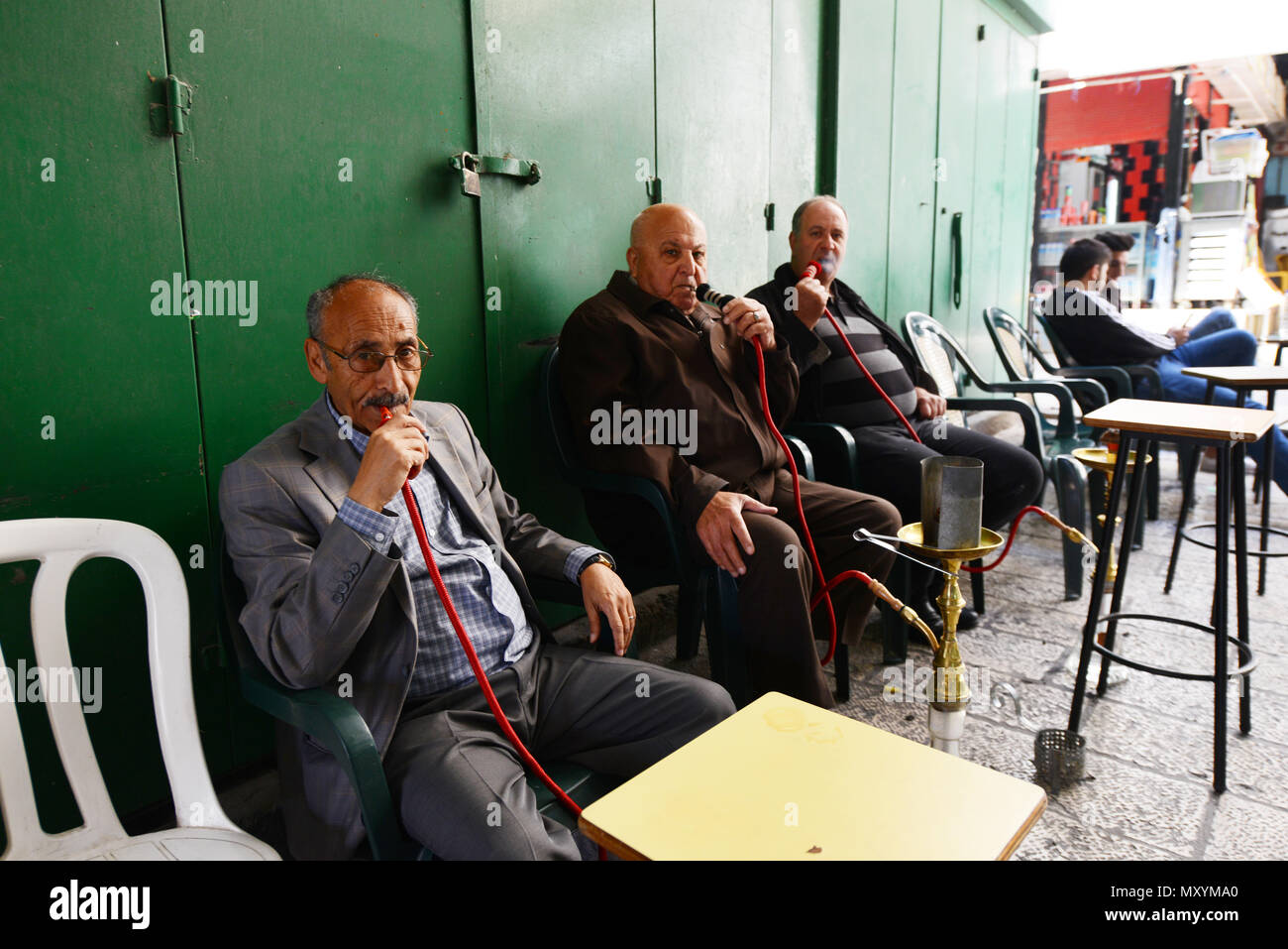 Palestinian men smoking Nargila in the old city of Jerusalem. Stock Photo