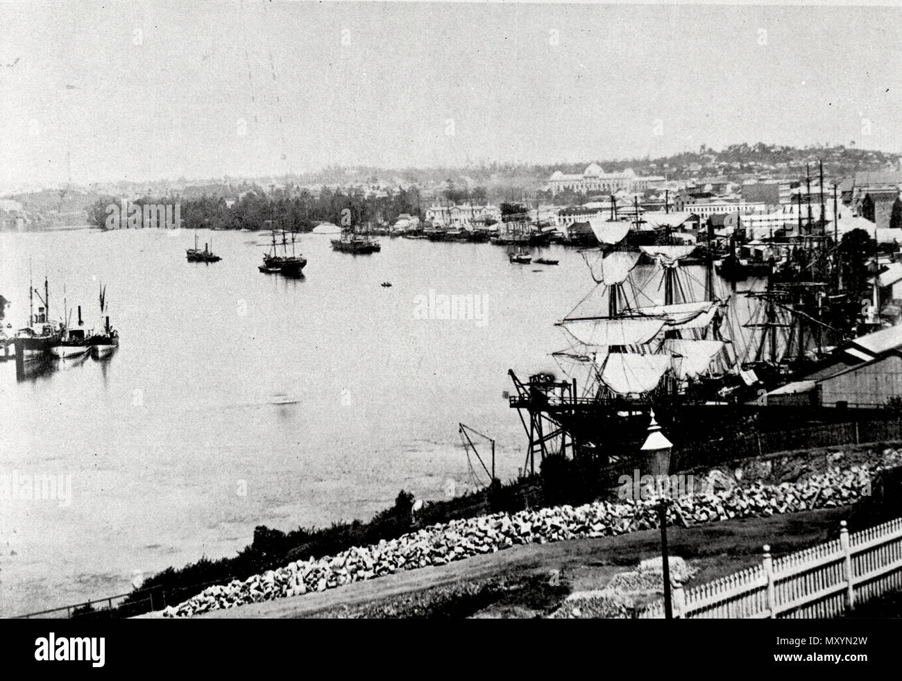 Looking along the Brisbane River in 1885. The Brisbane Courier Mon 17 Aug 1885  Sailing Matters By Tell Tale  The number of pleasure sailing boats on the Brisbane River is rapidly on the increase. The lastest addition of this kind is a handy little craft just turned out for Mr. Marlow by Mr. Miller, of Kangaroo Point. The Cecilia - the name given to her - is an 18ft. open centreboard boat, of nearly 6ft. beam. She is planked with cedar, on yellow-wood timbers, is varnished, and looks a neat and well-modelled craft, which ought to be both comfortable and fast under canvas.   The summer winds ar Stock Photo