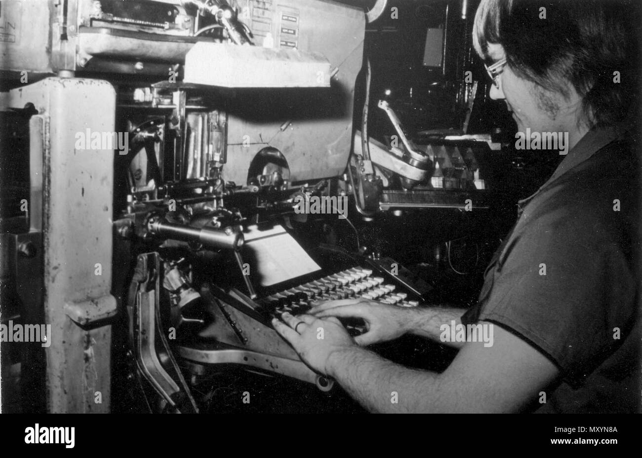 Apprentice linotype operator at Queensland Times, Ipswich, 1975. Linotype typesetting machine by which characters are cast in type metal as a compete line rather than as individual characters as on the Monotype typesetting machine. It was patented in the United States in 1884 by Ottmar Mergenthaler. Linotype, which has now largely been supplanted by photocomposition, was most often used when large amounts of straight text matter were to be set.  In the Linotype system, the operator selects a magazine containing brass matrices to mold an enti Stock Photo