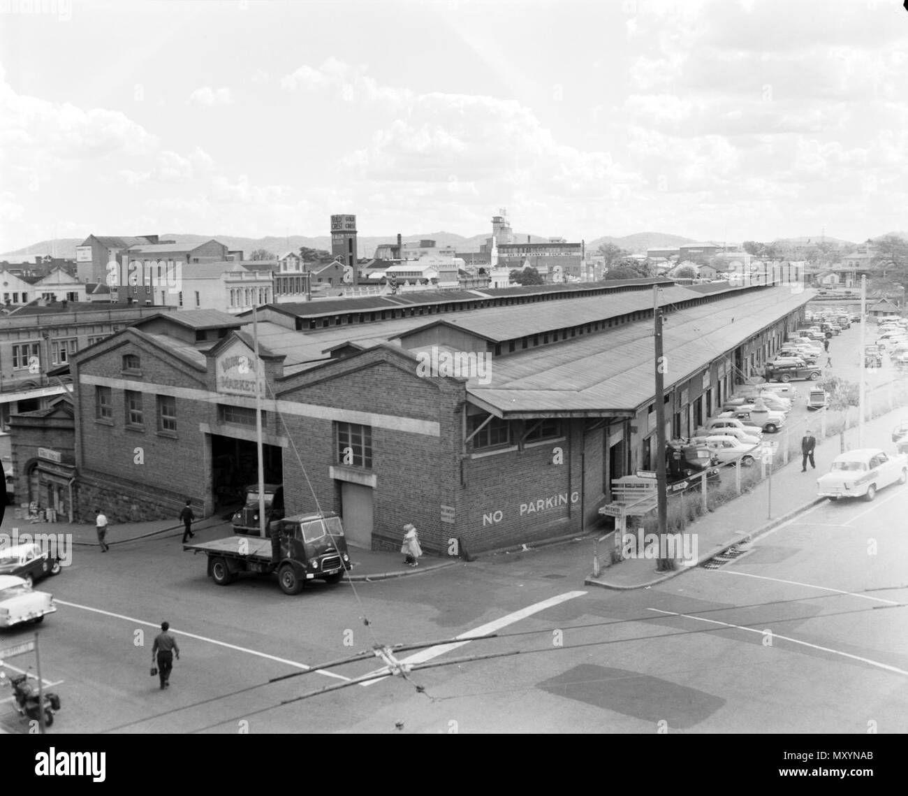 Municipal Markets, Brisbane, 1962. Brisbane’s first Central Market began in 1868 in a Brisbane Municipal Council built shed on the corner of Charlotte and Eagle Streets. It closed in 1881 due to poor patronage.  In 1885, the Council opened the purpose-built Municipal Market in Roma Street, beside the railway station.  Due to increasing congestion, the State Government agreed to move the Central Market to Rocklea in 1964, were the Brisbane Markets are located today. Stock Photo