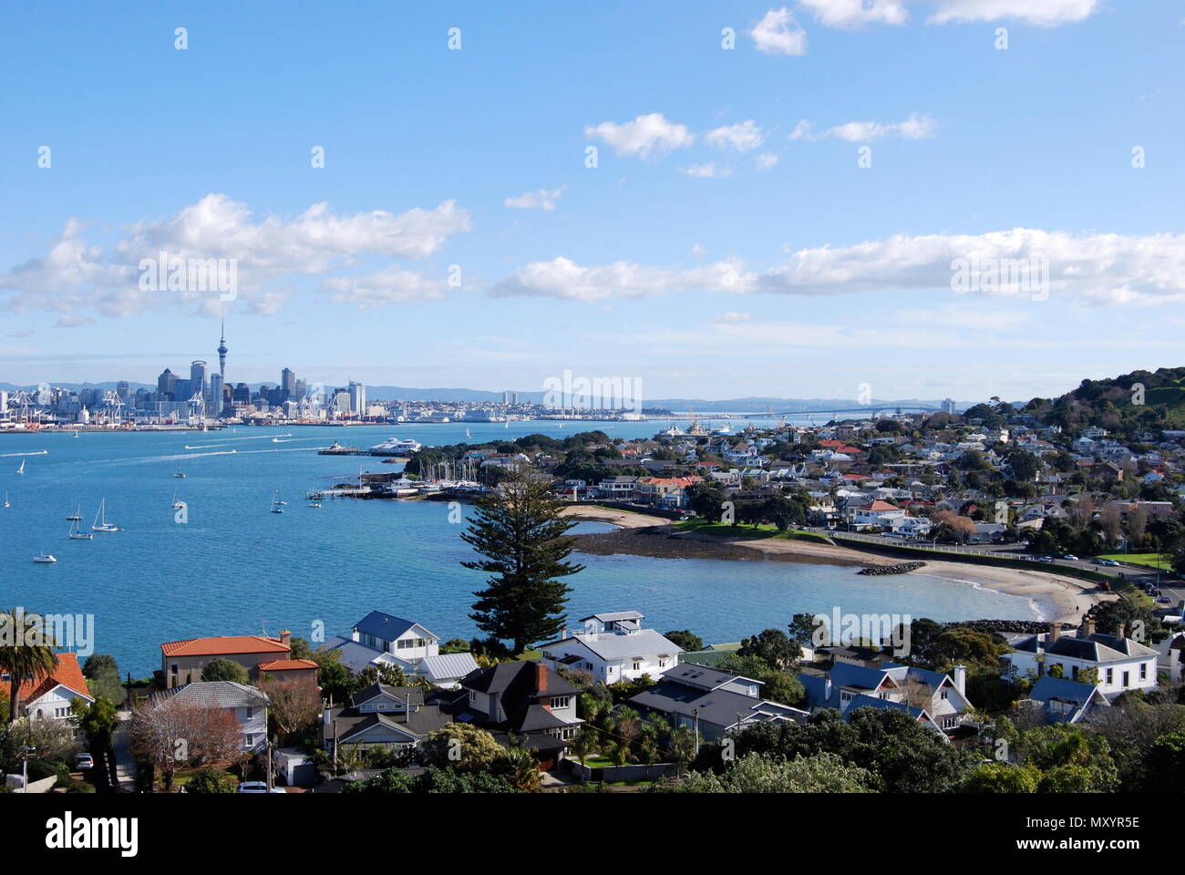Landscape photograph of Auckland Harbour from Devonport, North Shore, looking out over the water to the sky tower in Auckland city, New Zealand Stock Photo