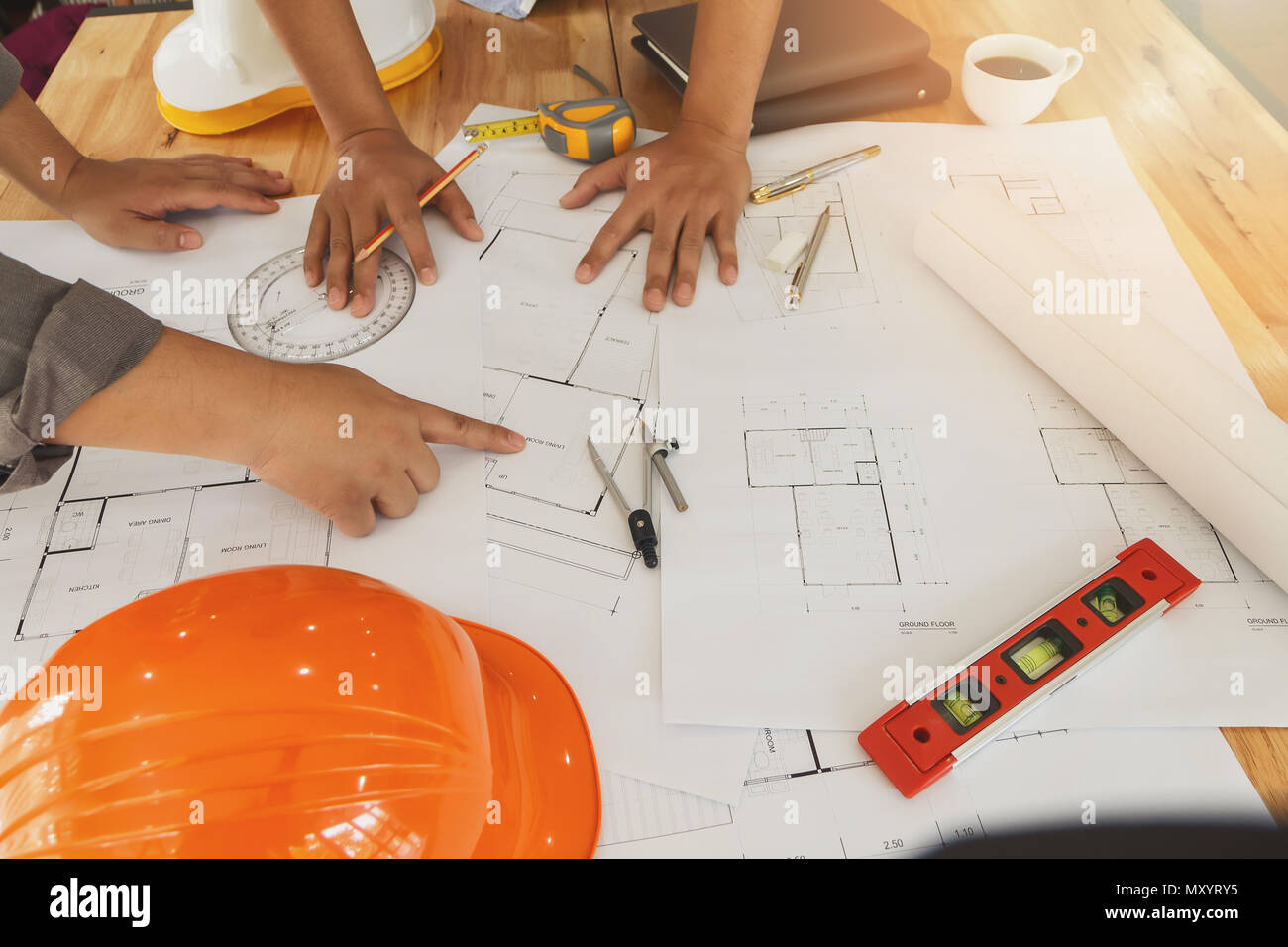 Architect or engineer working on blueprint, architectural concept. Engineer discussing with Architect team meeting and discussing project plan.Enginee Stock Photo