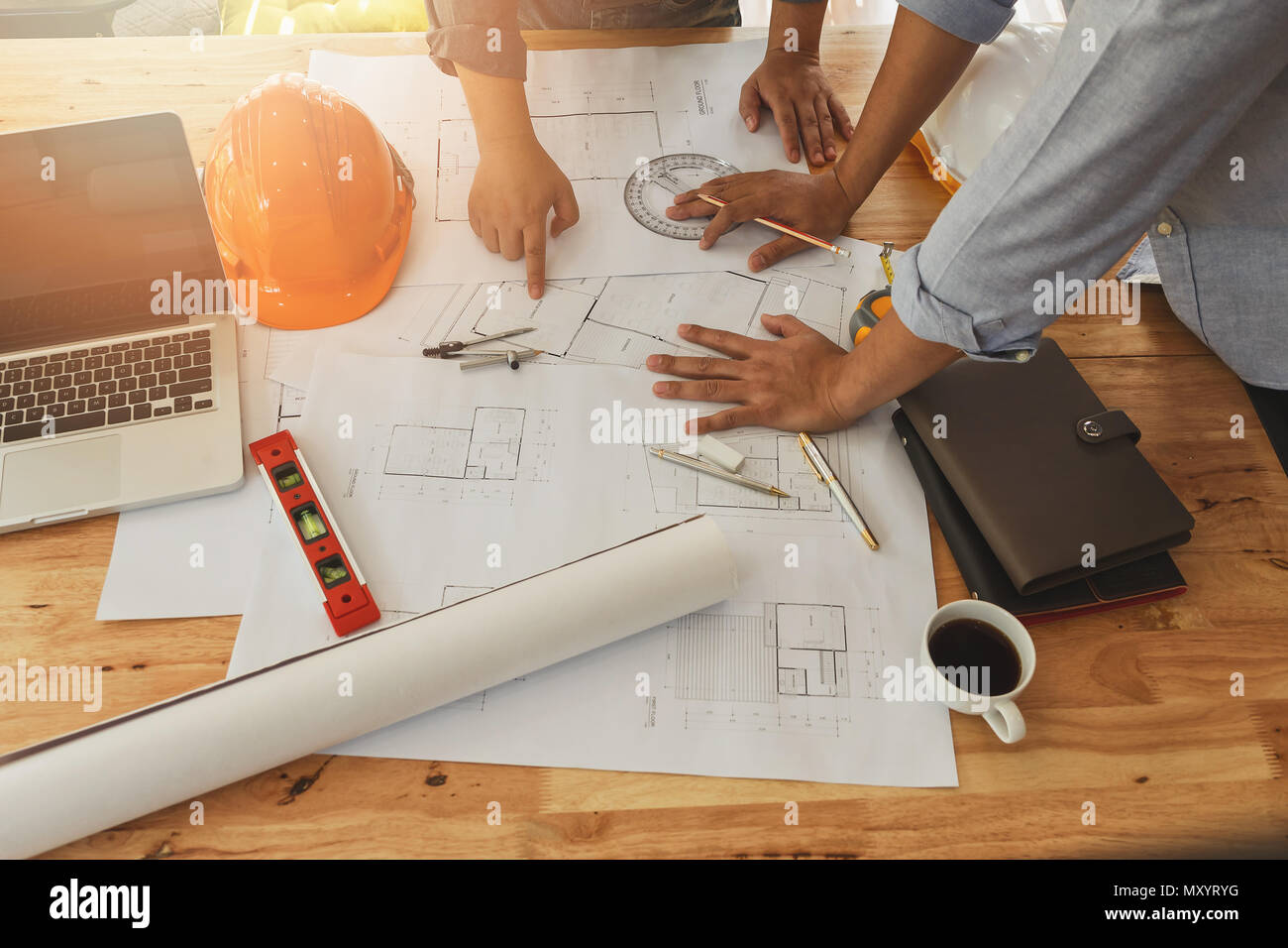 Architect or engineer working on blueprint, architectural concept. Engineer discussing with Architect team meeting and discussing project plan.Enginee Stock Photo