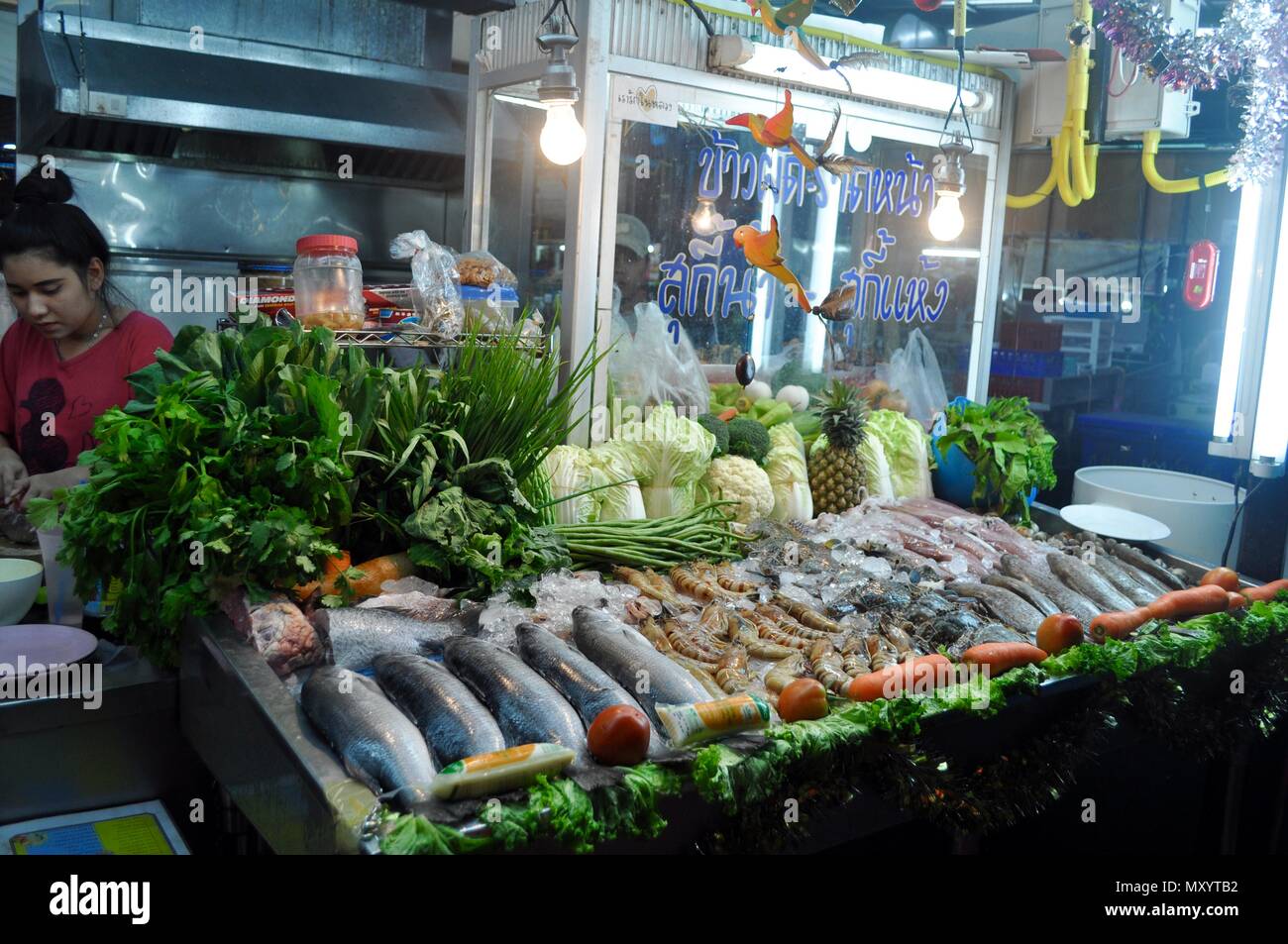 Food stand with fish and seafood on night market, Thailand Stock Photo