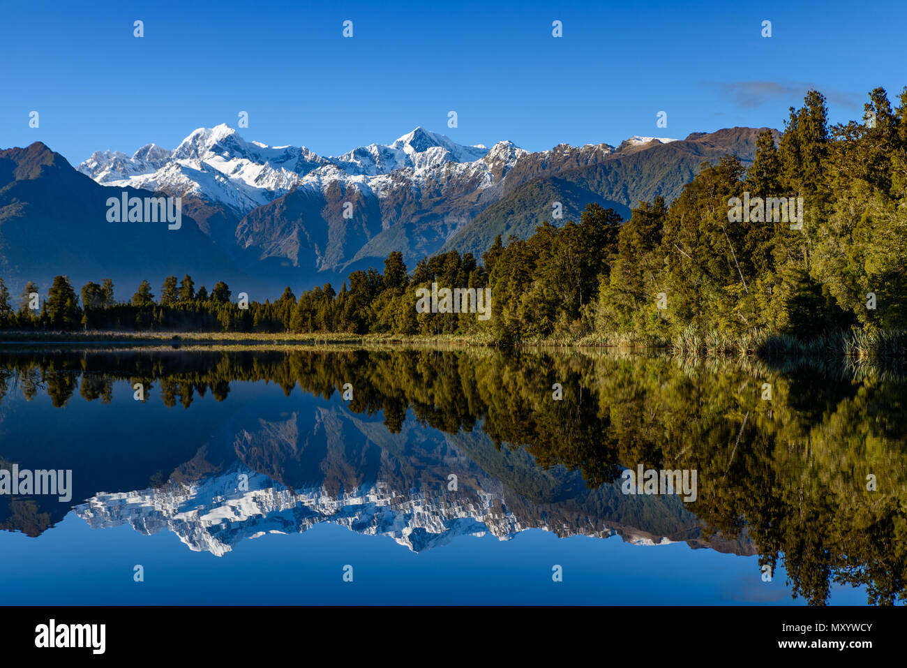 Lake Matheson with reflections on water, West Coast, New Zealand Stock Photo