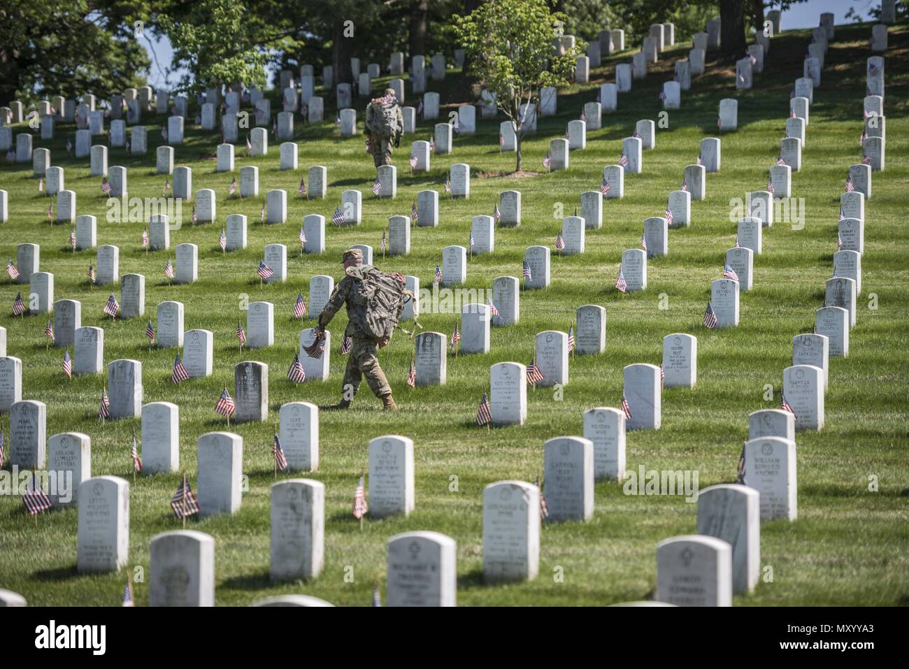 Soldiers from the 3d U.S. Infantry Regiment (The Old Guard) place U.S. flags at headstones in Section 38 during Flags In at Arlington National Cemetery, Arlington, Virginia, May 24, 2018, May 24, 2018. For more than 60 years, Soldiers from the Old Guard have honored our nation's fallen heroes by placing U.S. flags at gravesites for service members buried at both Arlington National Cemetery and the U.S. Soldiers' and Airmen's Home National Cemetery just prior to the Memorial Day weekend. Within four hours, more than 1, 000 Soldiers placed 234, 537 flags in front of every headstone and Columbari Stock Photo