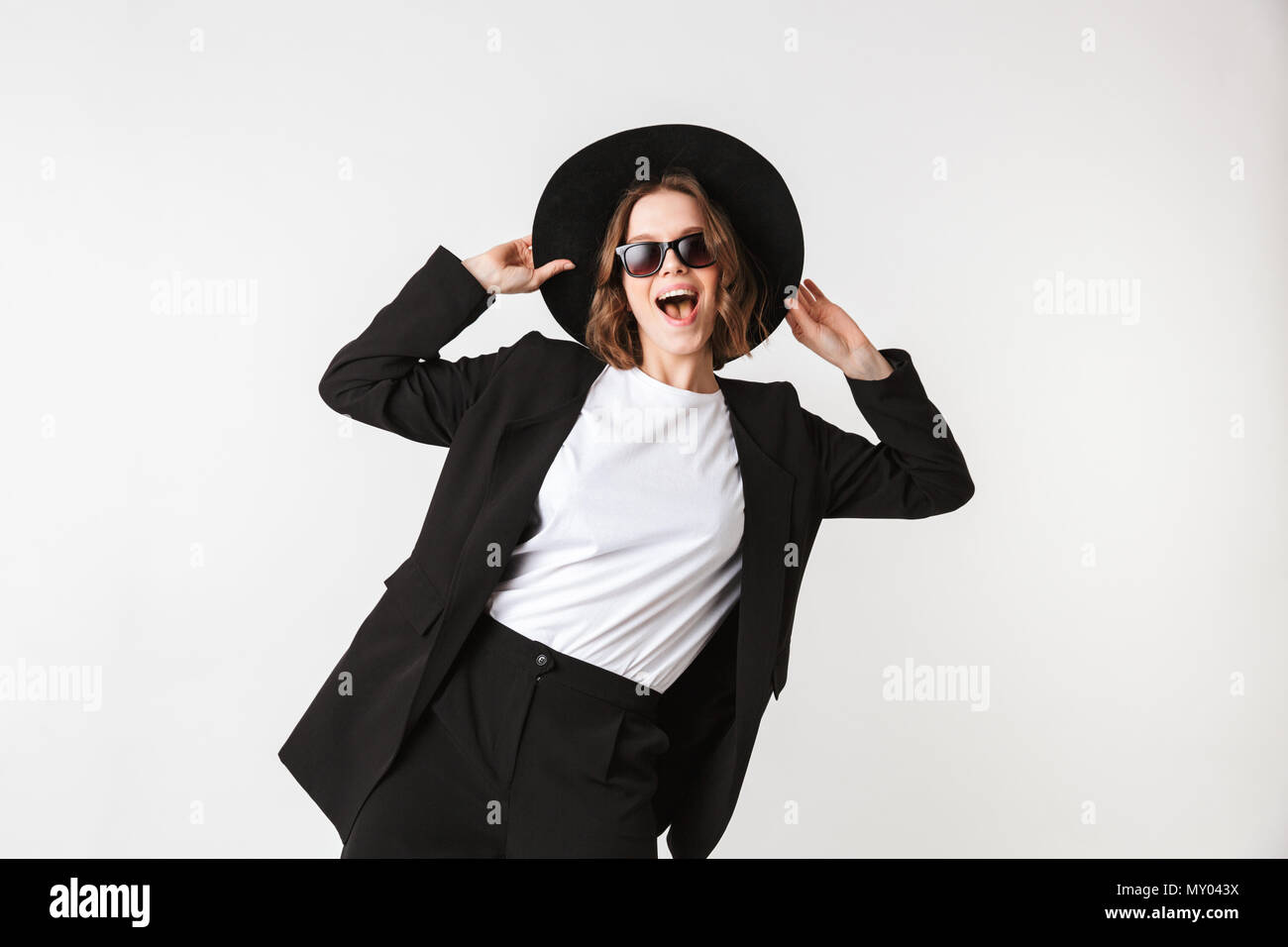 Portrait of a pretty young woman dressed in black jacket and sunglasses ...