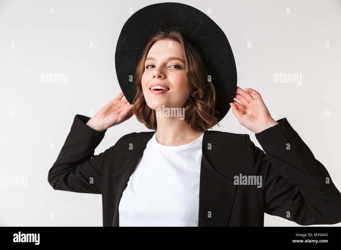 Portrait of a beautiful young woman dressed in black jacket and ...