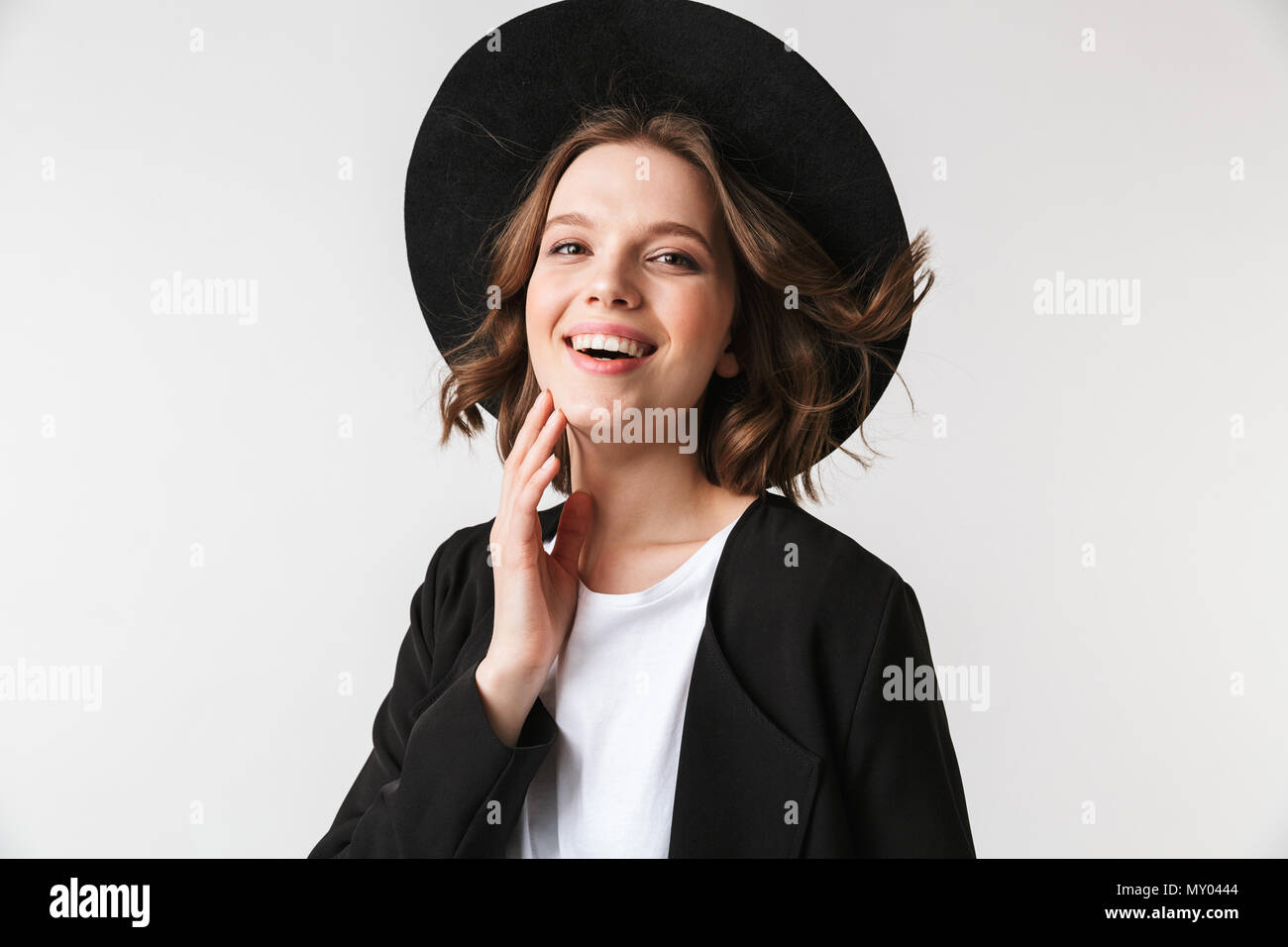 Portrait of a laughing young woman dressed in black jacket and ...