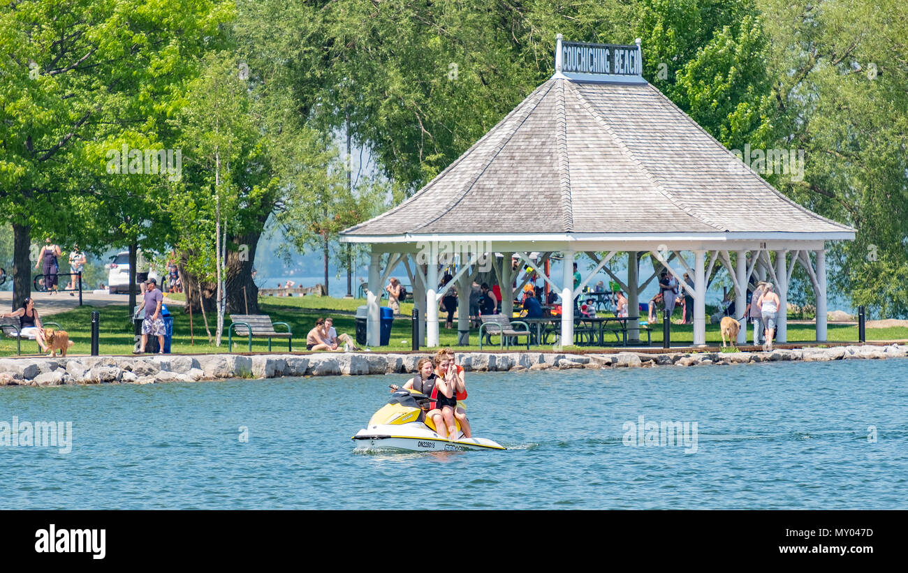 Three teens enjoy a day on the lake with a personal watercraft at Orillia Ontario Canada. Stock Photo