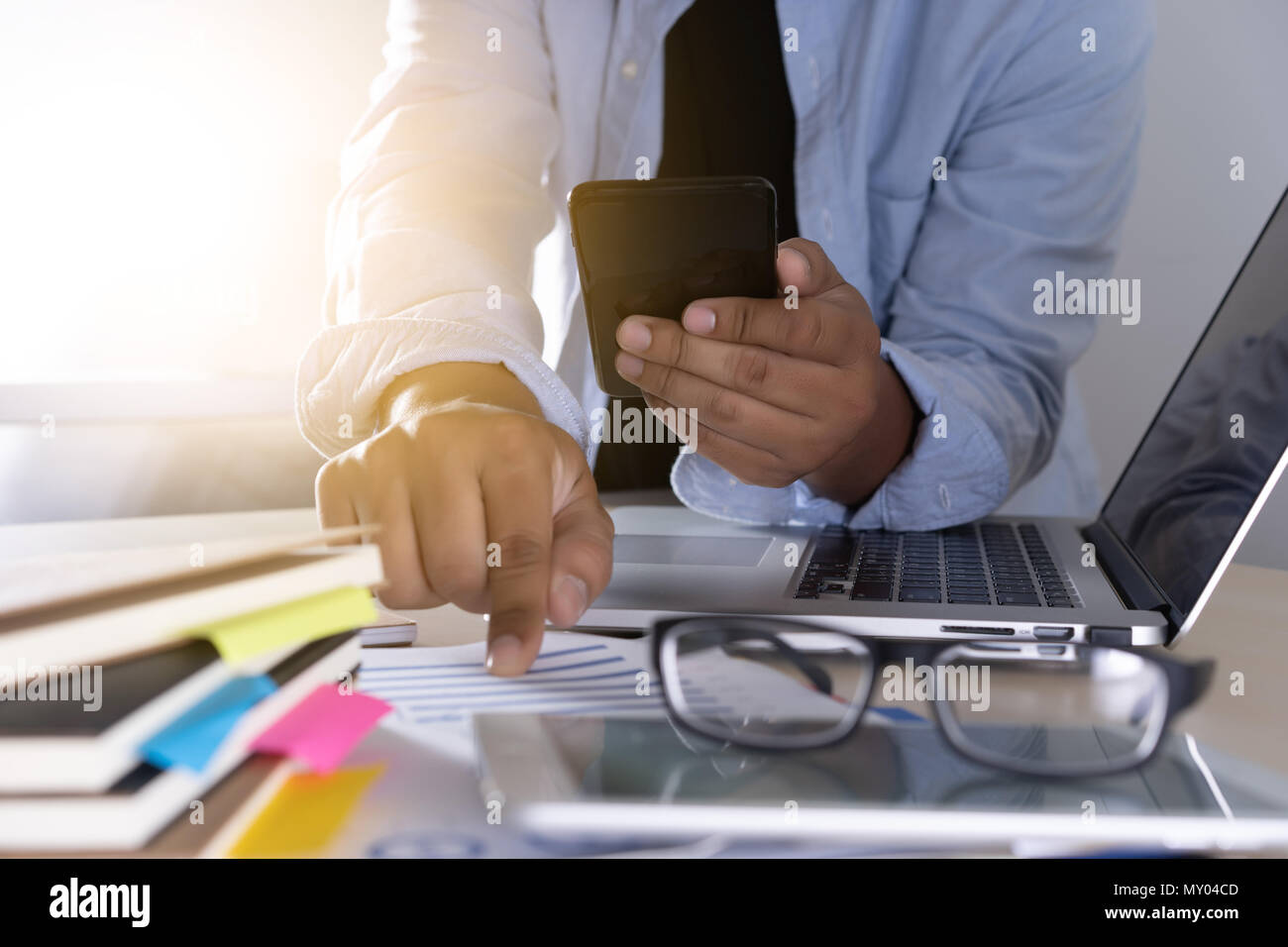 businessman using phone smart phone and notebook computer Stock Photo