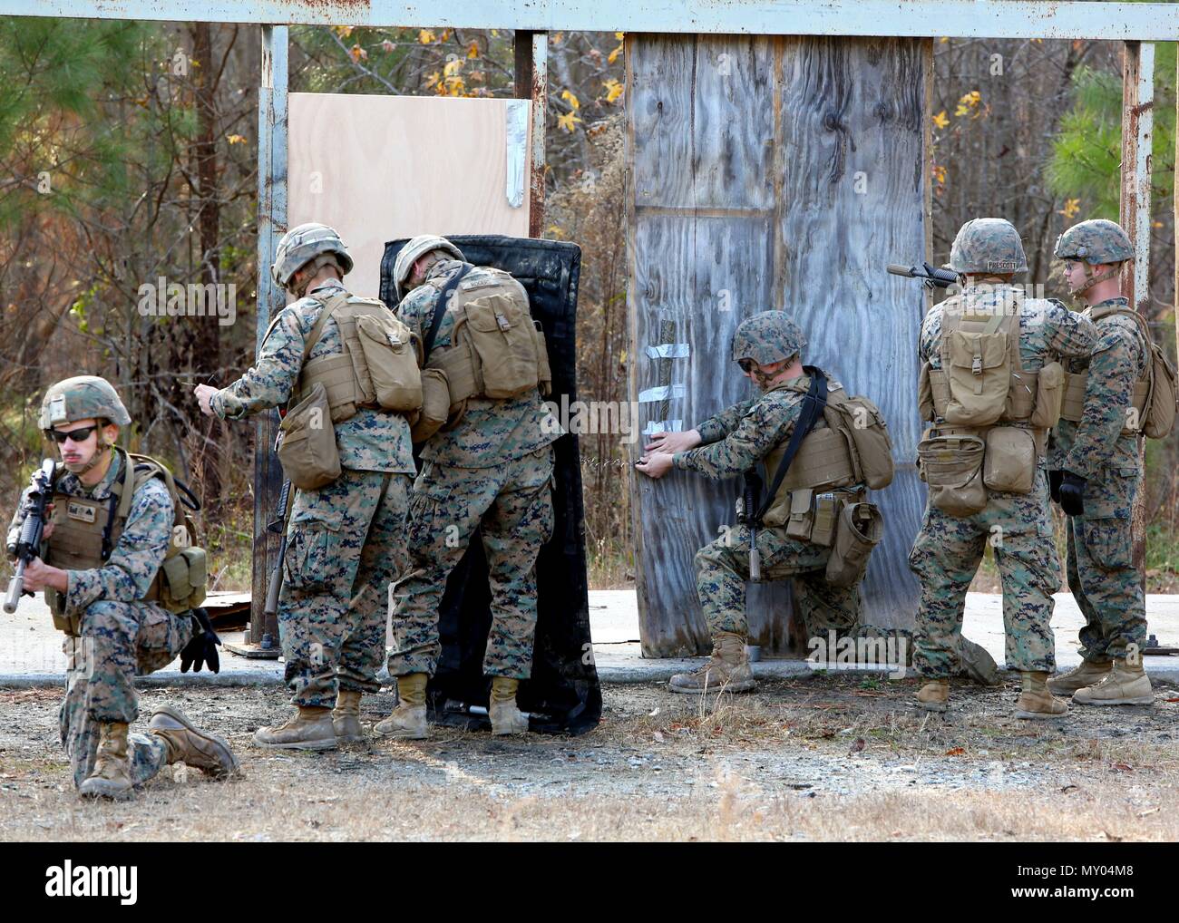 Marines place a detonation cord linear charge on a door for an urban