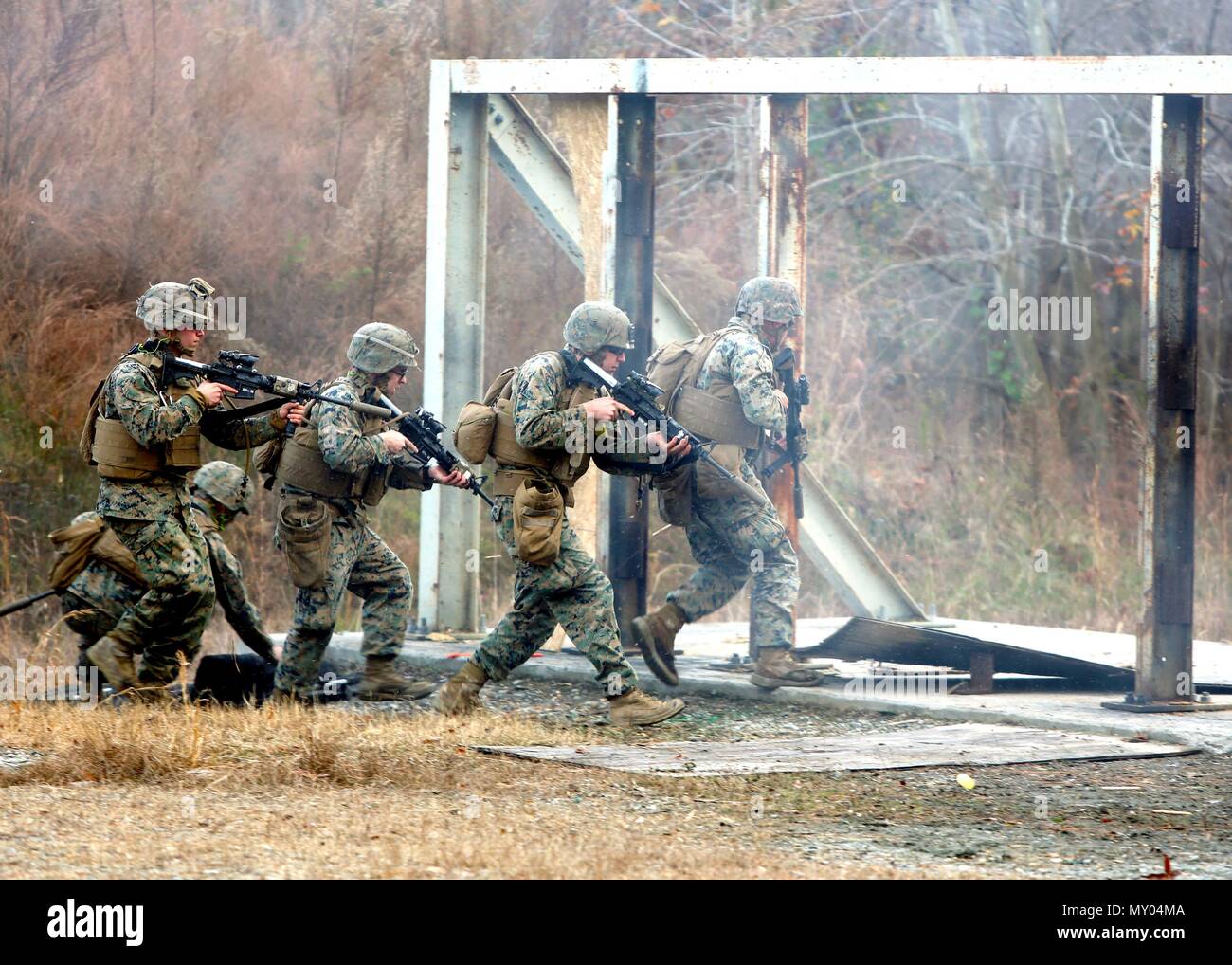 Marines practice assaulting through a doorway after setting off an explosive charge for an urban assault breaching range during a deployment for training exercise at Fort Pickett, Va., Dec. 8, 2016. The training was a learning experience for the Marines to improve their assault breaching skills. The Marines are with Charlie Company, 2nd Combat Engineer Battalion. (U.S. Marine Corps photo by Sgt. Clemente C. Garcia) Stock Photo