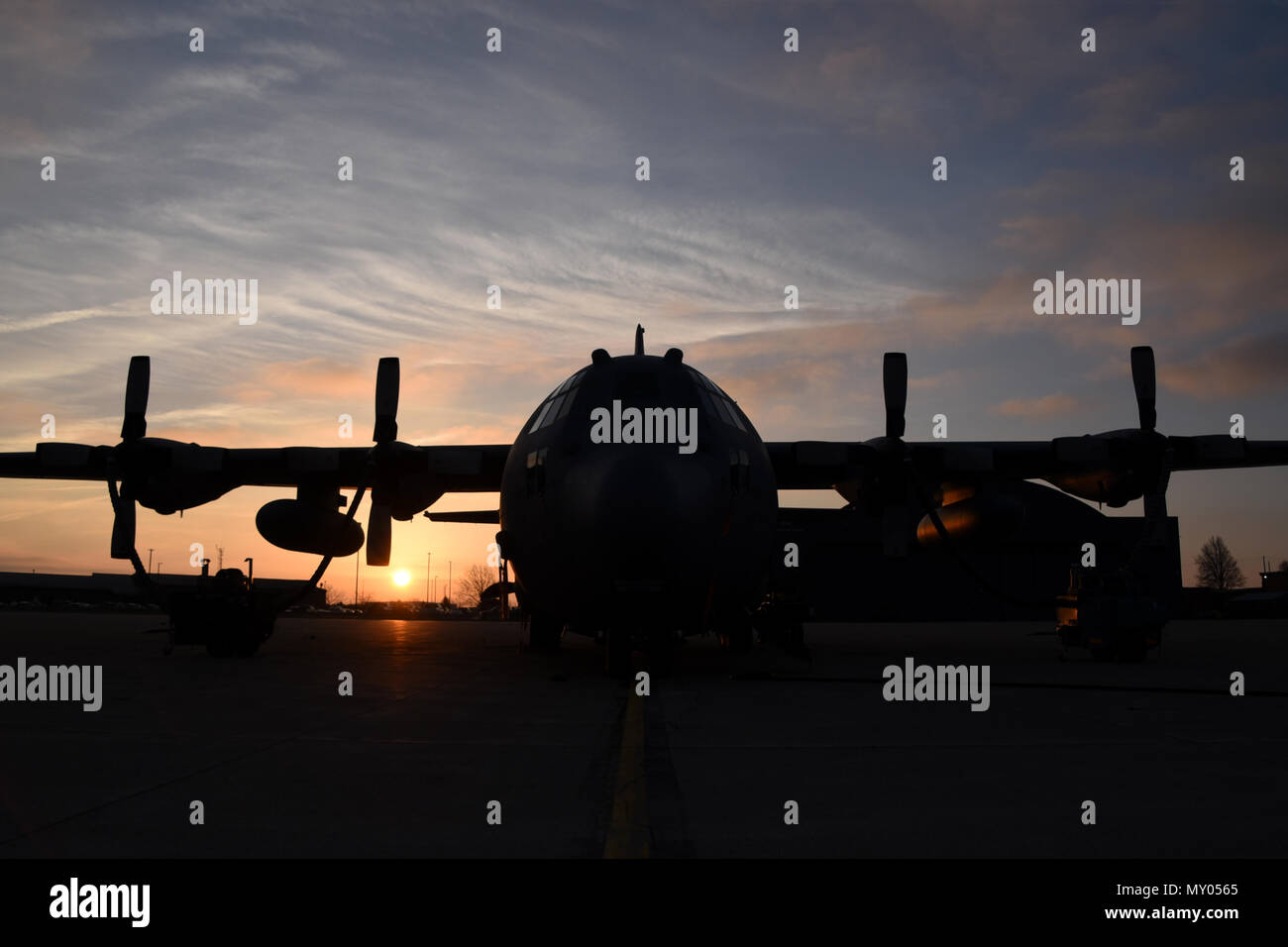 The sun rises over the flightline at the 179th Airlift Wing, Mansfield, Ohio, casting its morning glow on the C-130H Hercules on Dec. 28, 2016. The 179th Airlift Wing is always on a mission to be the first choice to respond to community, state and federal missions with a trusted team of highly qualified Airmen. (U.S. Air National Guard photo by Airman Megan Shepherd/Released) Stock Photo