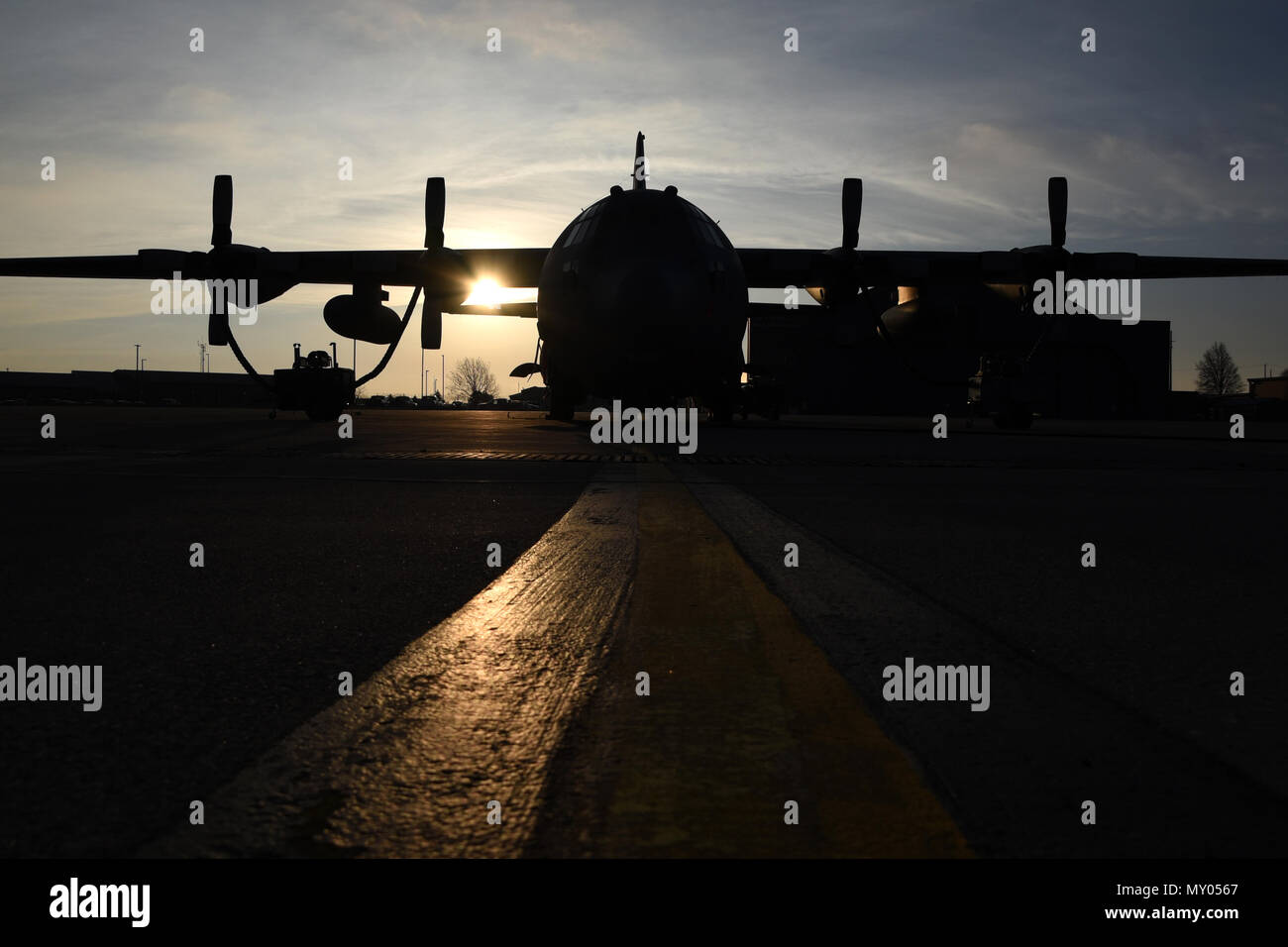 The sun rises over the flightline at the 179th Airlift Wing, Mansfield, Ohio, casting its morning glow on the C-130H Hercules on Dec. 28, 2016. The 179th Airlift Wing is always on a mission to be the first choice to respond to community, state and federal missions with a trusted team of highly qualified Airmen. (U.S. Air National Guard photo by Airman Megan Shepherd/Released) Stock Photo