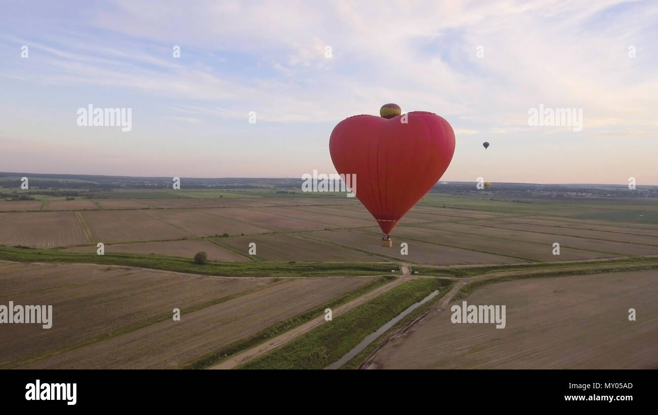 Hot air balloon shape of a heart in the blue sky. Aerostat, Airship ...