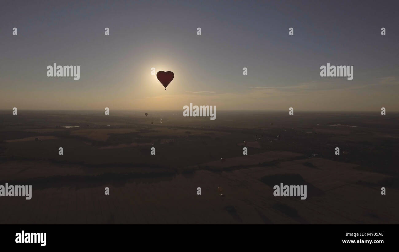 Hot air balloon shape of a heart in the blue sky. Aerostat, Airship ...