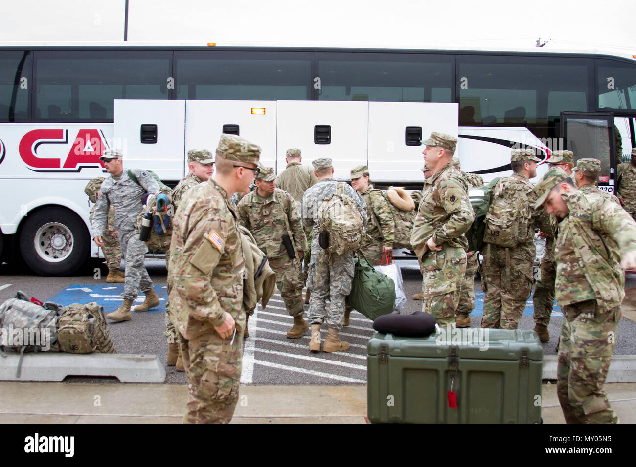 Soldiers of the 45th Infantry Brigade Combat Team unload a bus donated ...