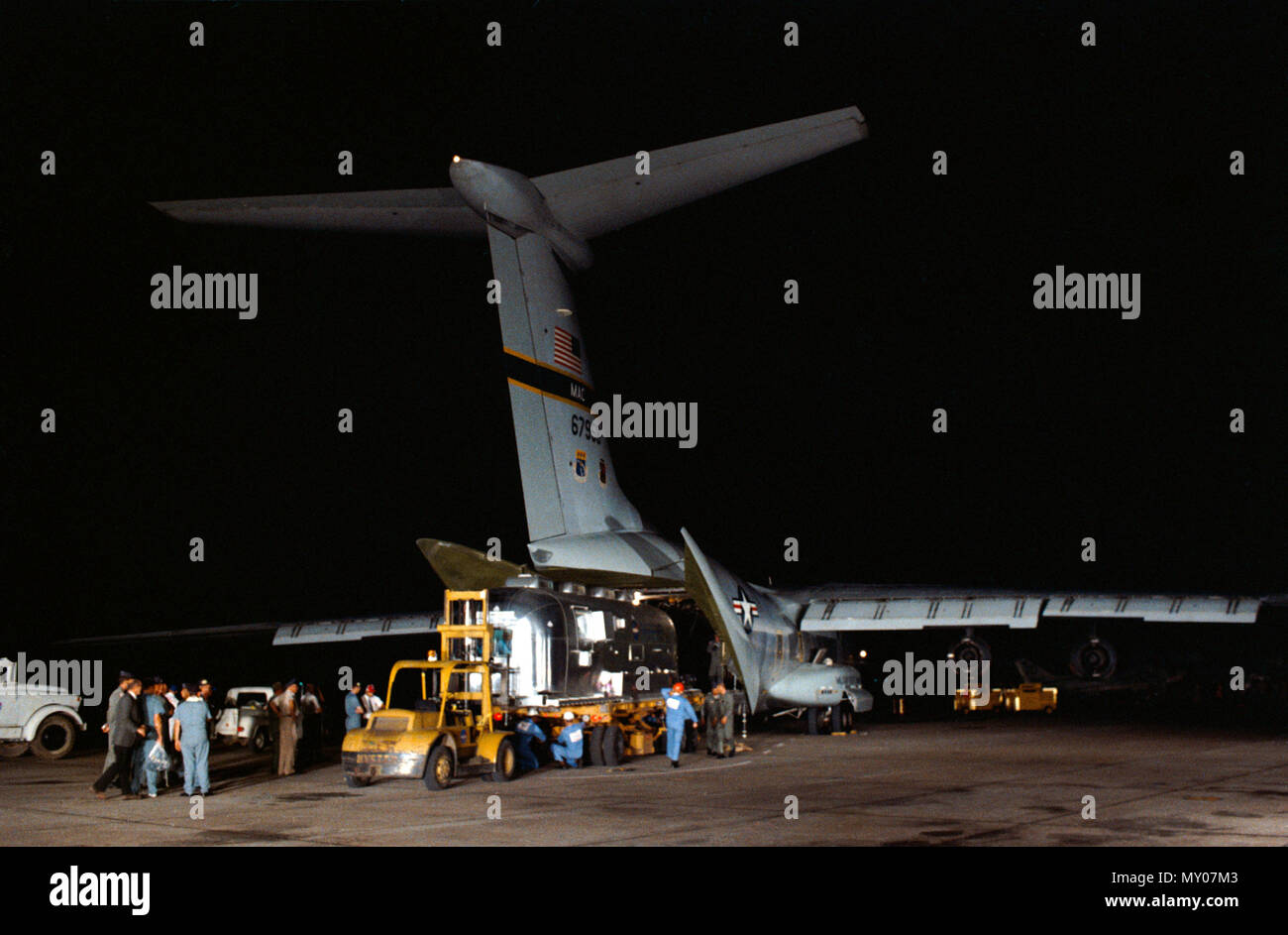 (27 July 1969) --- A Mobile Quarantine Facility (MQF), with the three Apollo 11 crewmembers inside, is unloaded from a United States Air Force C-141 transport at Ellington Air Force Base very early Sunday afte Stock Photo