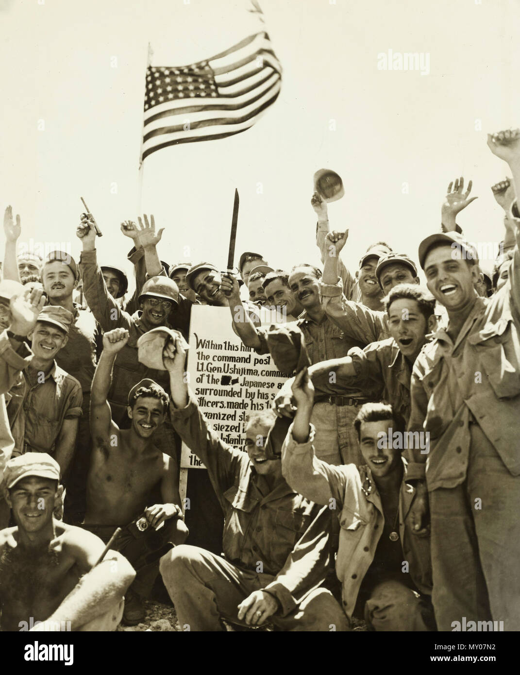 1st Div Marines and 7th Div Soldiers cheer a victory atop hill number 89 --thus ending the battle of Okinawa - Stock Photo