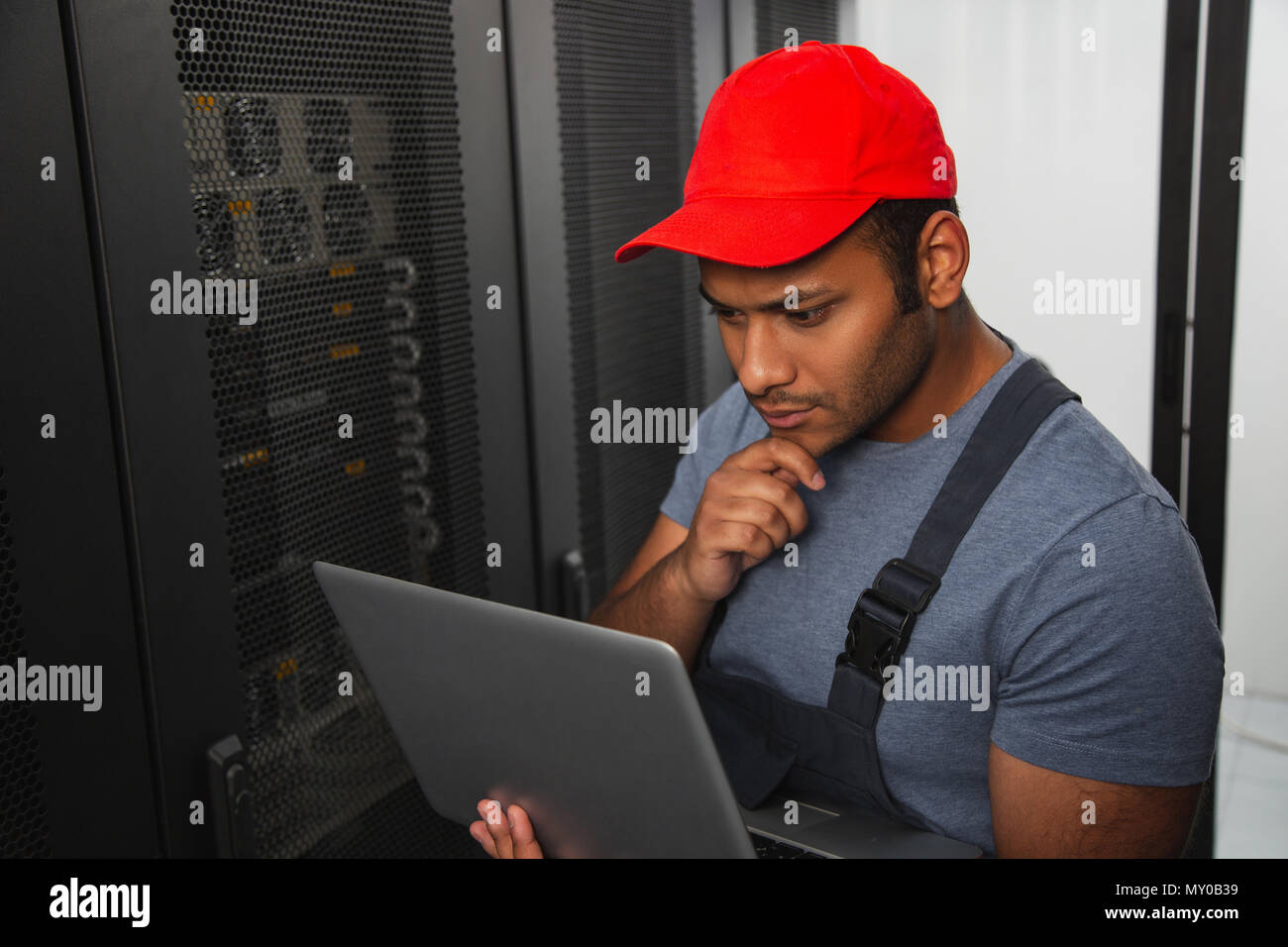 Pensive IT engineer fixing bug Stock Photo Alamy