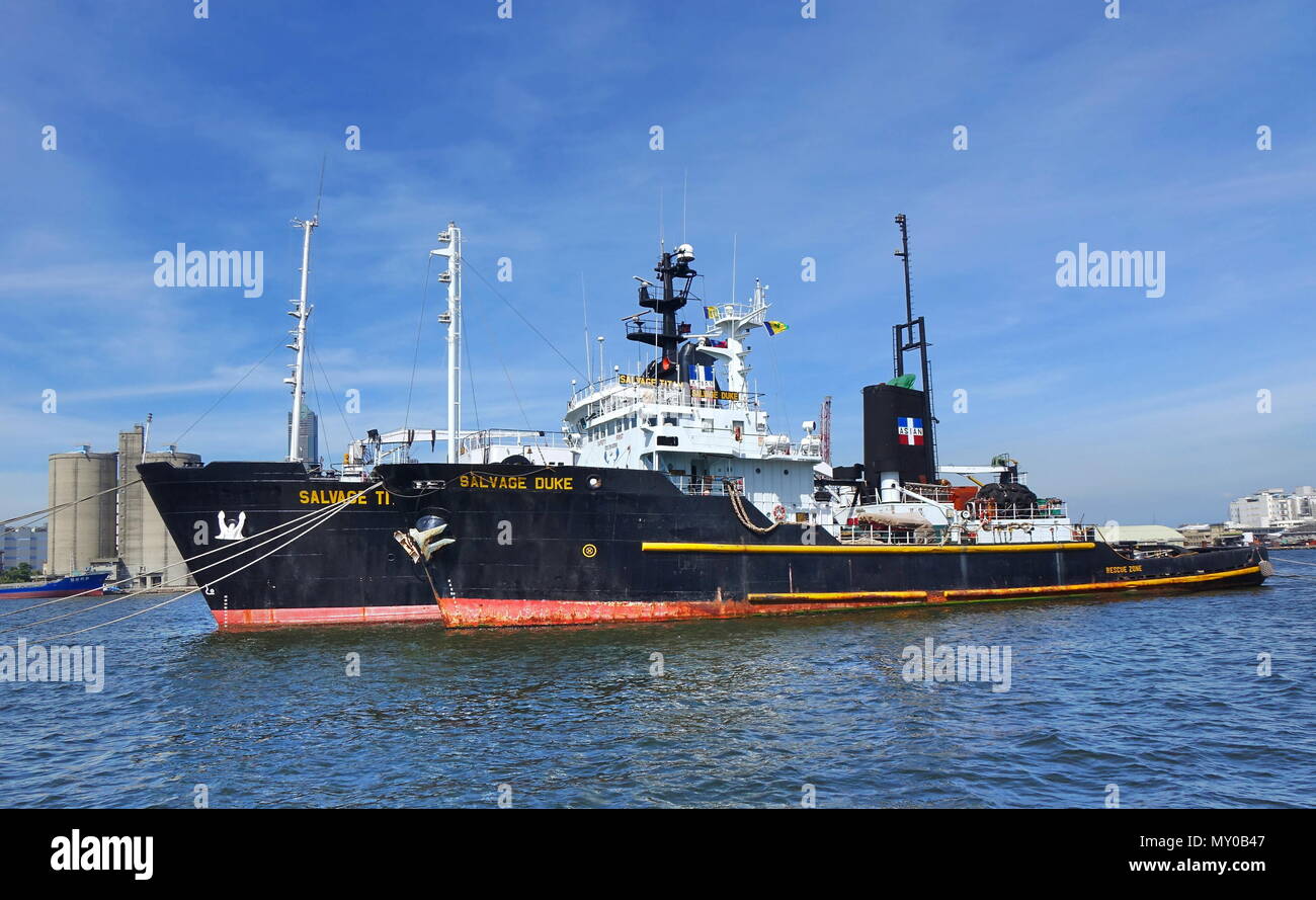 KAOHSIUNG, TAIWAN -- MAY 26, 2018: Two large ocean-going tugs are anchored in the busy port of Kaohsiung, a major trading hub for Taiwan. Stock Photo