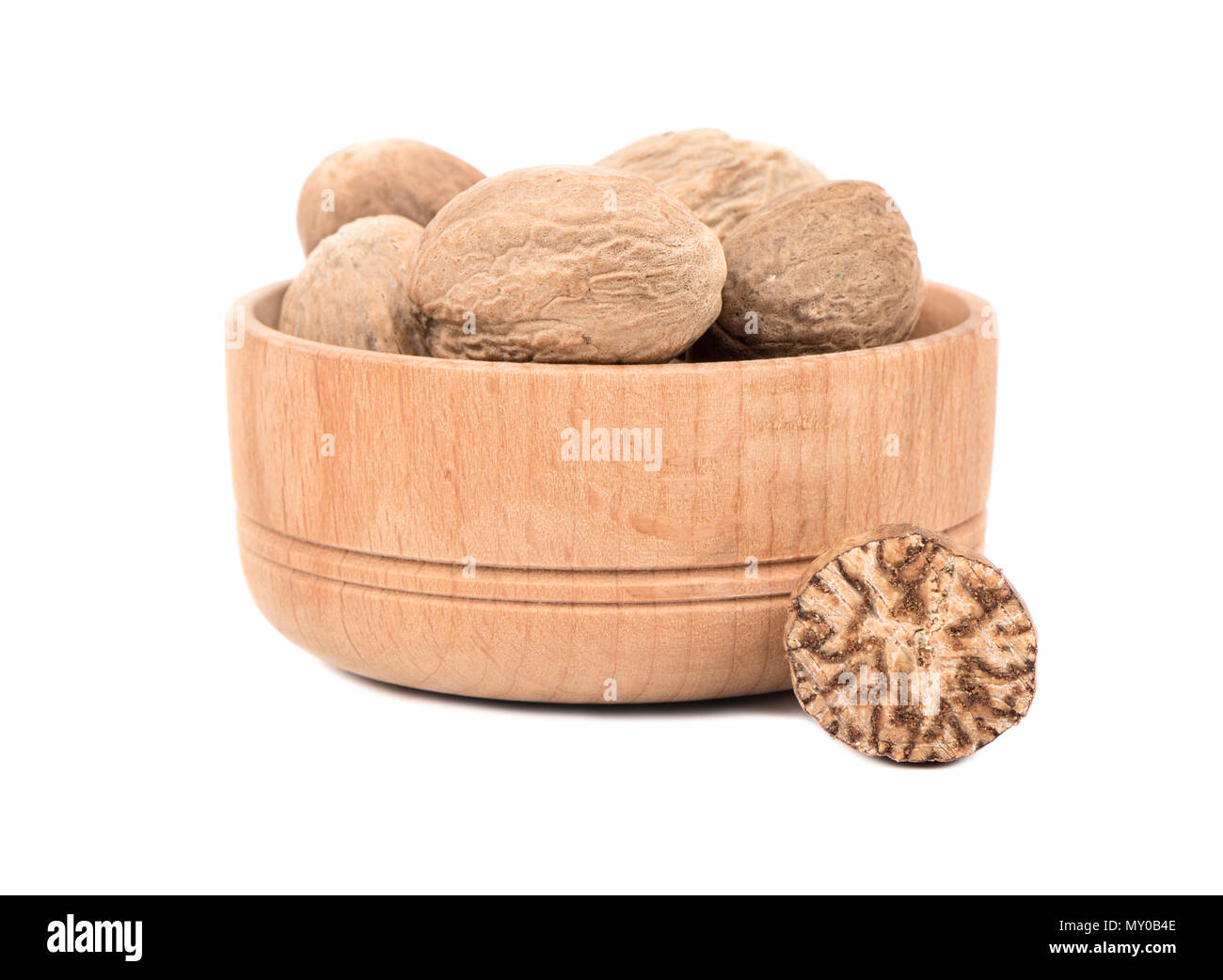 Dry nutmeg in a bowl with half on white background Stock Photo Alamy